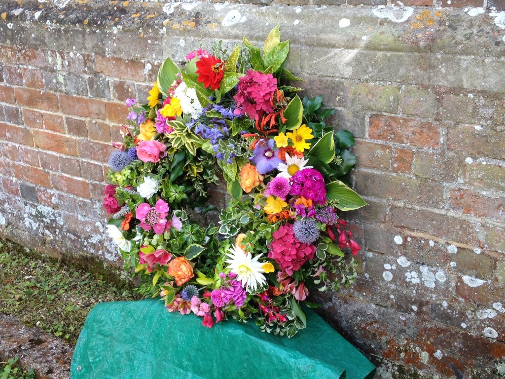 The beautiful informal commemoration wreath made from flowers from gardens in the village