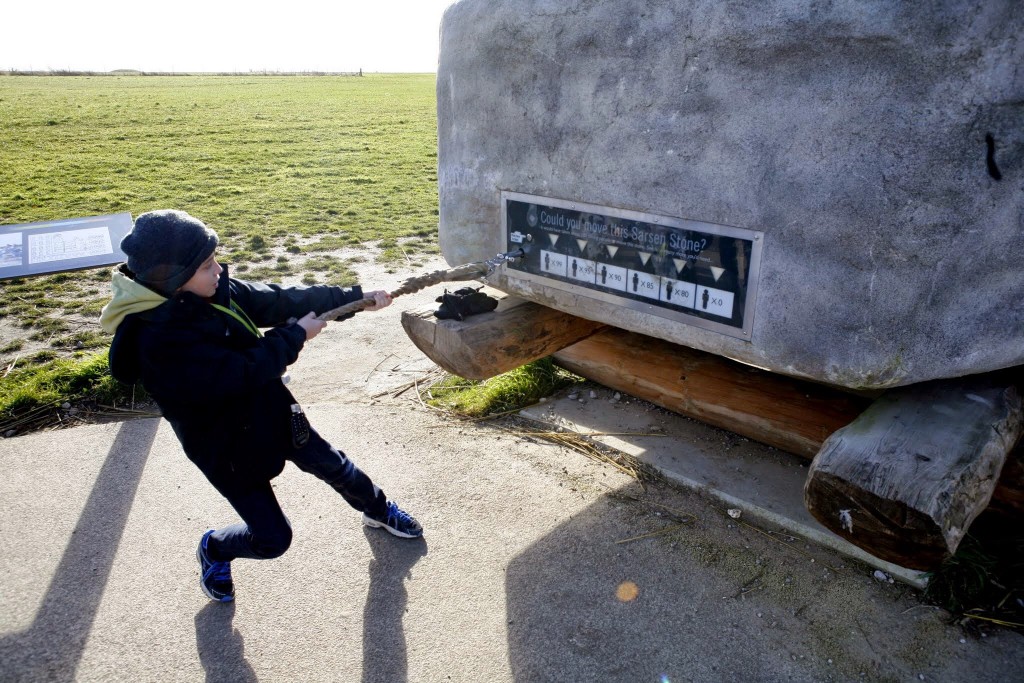 The Boy attempting to pull the stone